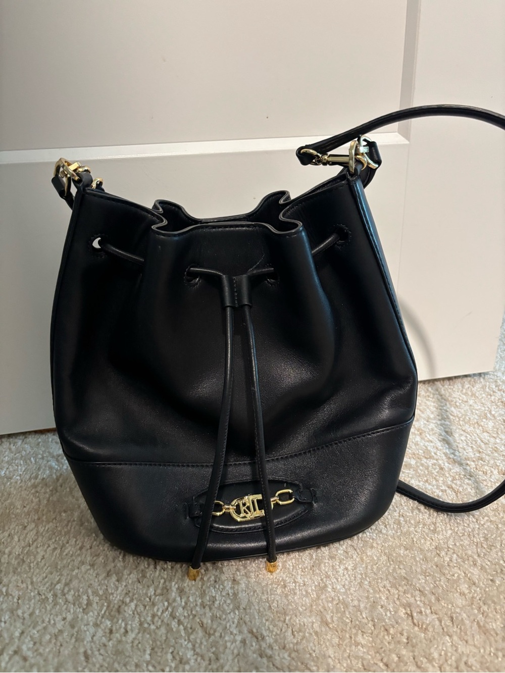 black leather drawstring bucket bag with shoulder or crossbody strap